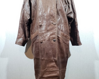 Stylish women's brown leather coat. Brown women's coat made of genuine leather.