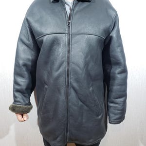 Stylish men&#39;s black sheepskin coat. Reliable men&#39;s sheepskin coat with zipper.