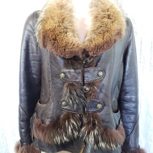 A wonderful women&#39;s warm sheepskin coat made of genuine fur. Stylish brown sheepskin coat with decorative buttons.