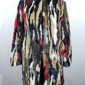 Delightful women&#39;s multicolored faux fur coat. Stylish multicolored women&#39;s coat.