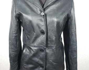 May include: A black leather jacket with a classic design. The jacket features a notched collar, three buttons down the front, and a tailored fit. The jacket is displayed on a mannequin.