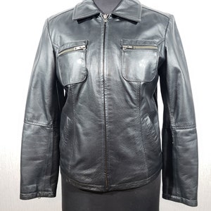 Stylish women&#39;s black leather jacket made of genuine leather. Reliable women&#39;s black jacket with a zipper.