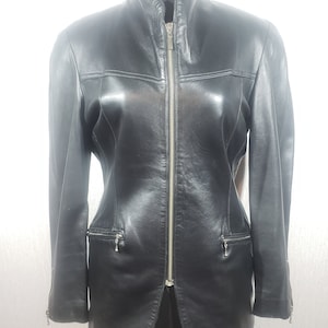 Stylish women&#39;s black leather jacket made of genuine leather. Reliable women&#39;s black jacket with a zipper.
