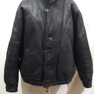 Reliable men&#39;s black sheepskin coat. Black sheepskin coat for men with buttons.