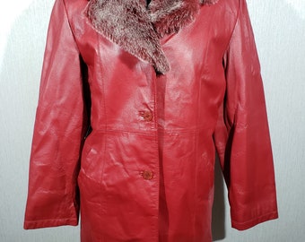 Stylish red women's leather raincoat. Cute women's leather jacket with a fur collar.