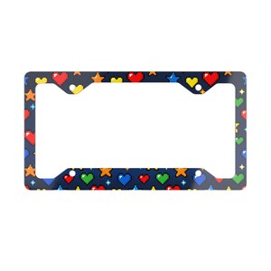 May include: A dark blue license plate frame with a repeating pattern of pixelated hearts, stars, and diamonds in various colors. The frame has a rectangular shape with cutouts for mounting.