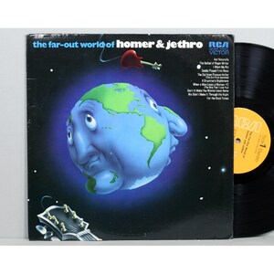 May include: Vinyl record album cover art featuring a cartoon illustration of the Earth with a face. The album is titled "The Far-Out World of Homer & Jethro" and features a list of songs on the back cover. The album is by RCA Victor.