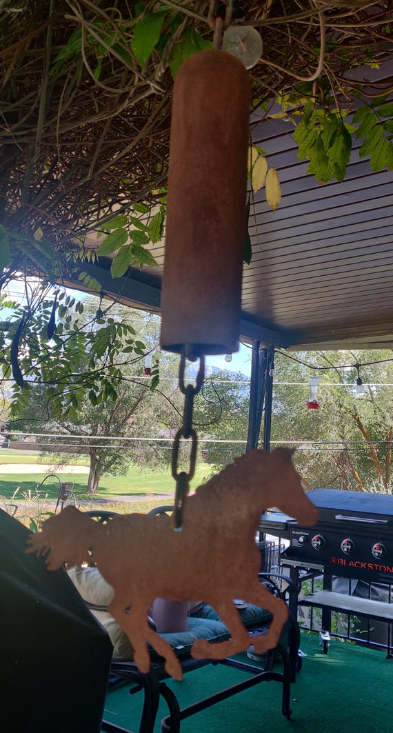 Rusty Horse bell made out of scrap steel with hanging horse.