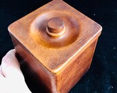 Vintage handcrafted wooden box covered in brown leather. Uniquely shaped leather box lined in wood. Brown leather box with lid.