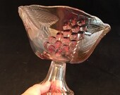 Mid century carnival glass pedestal bowl. Amber, pink, and green glass fruit bowl. Pressed glass cherries, grapes, strawberries , and leaves