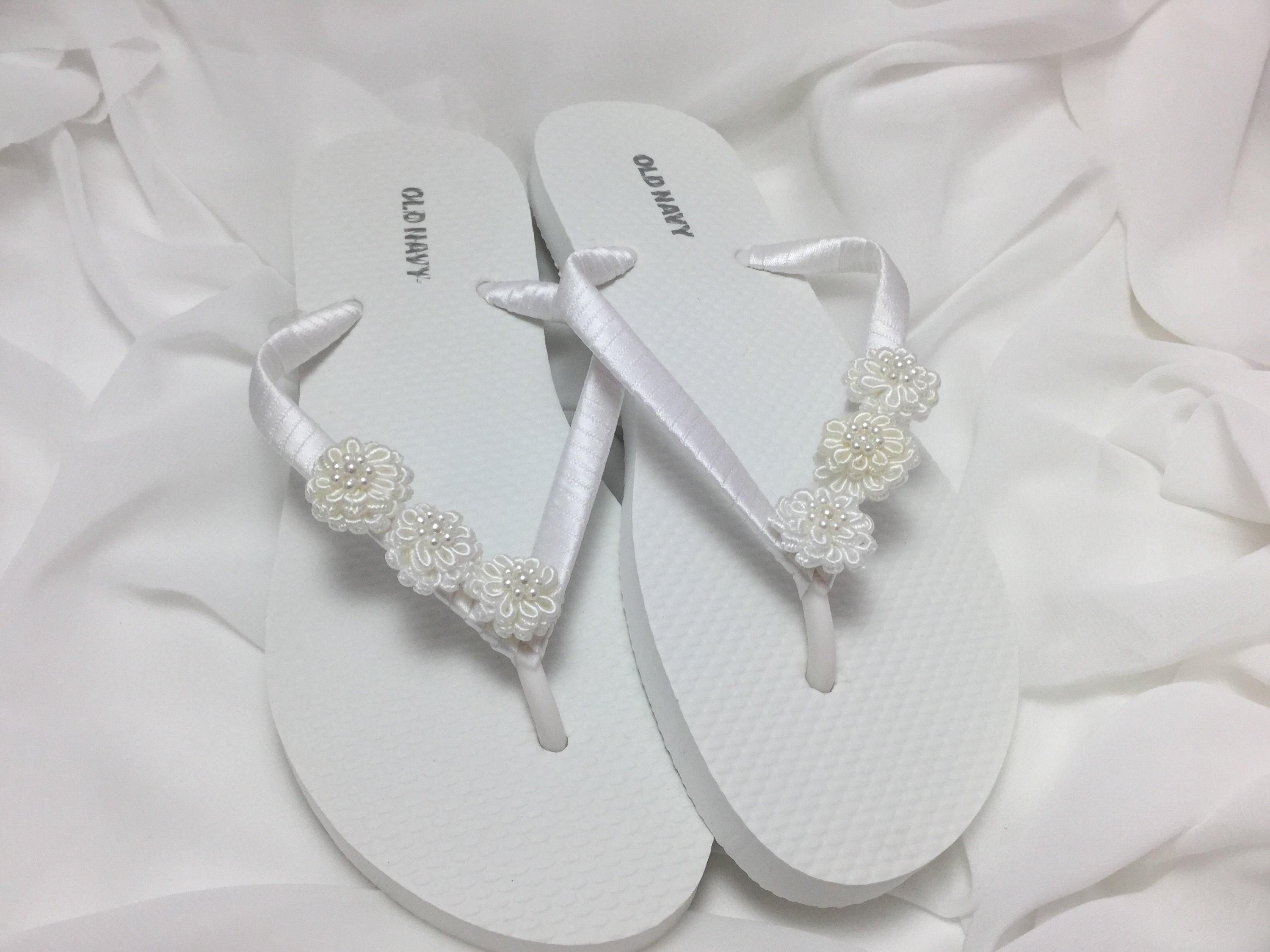 white flower flip flops