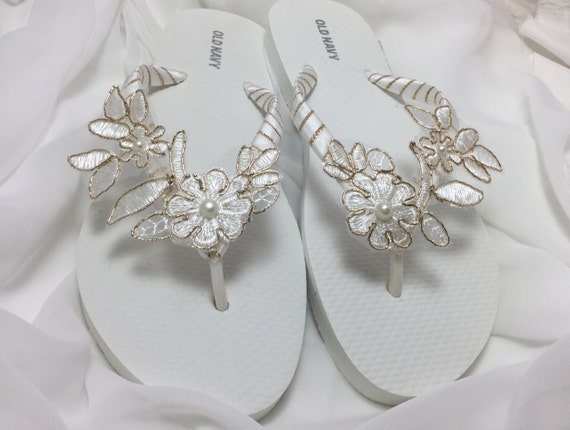 gold and white flip flops