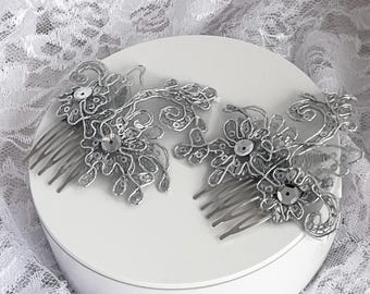May include: Two silver hair combs with delicate floral designs and sparkling sequins. The combs are perfect for adding a touch of elegance to any hairstyle.
