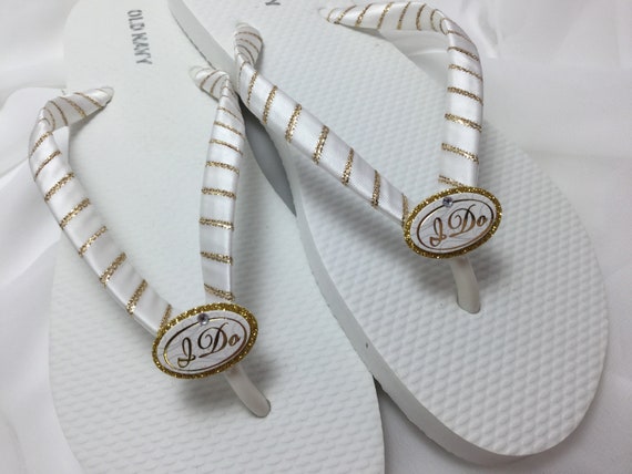 gold and white flip flops