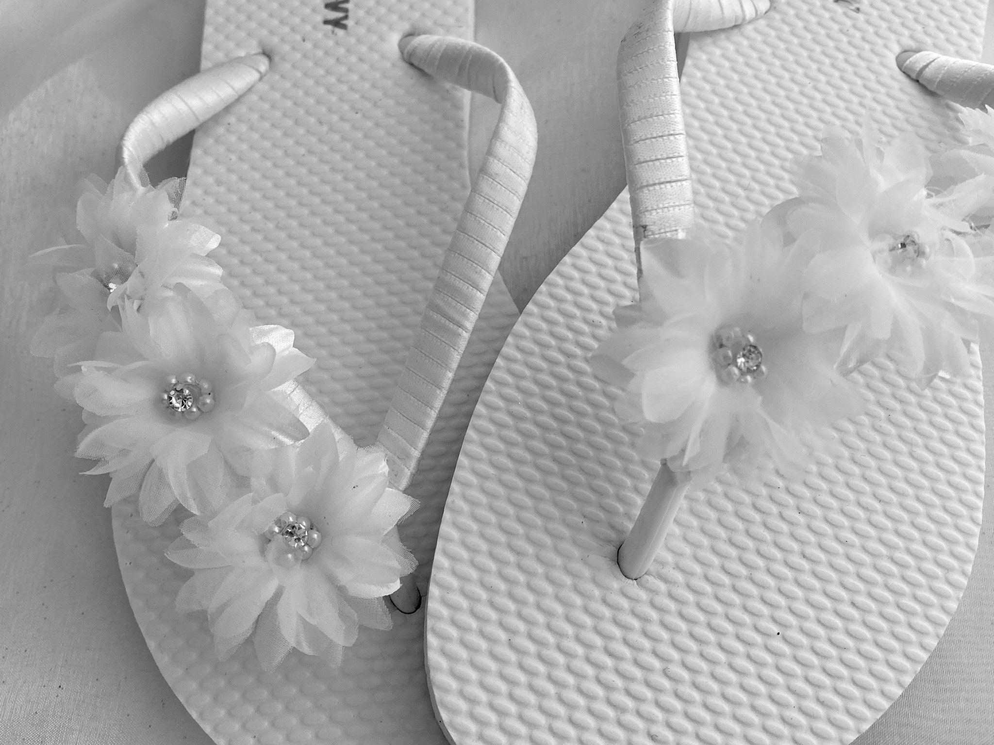white flower flip flops