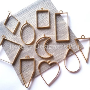 May include: Assortment of gold metal pendant frames in various shapes, including a heart, oval, crescent moon, teardrop, triangle, square, rectangle, and diamond.  These frames are perfect for resin art and jewellery making.