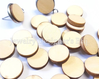 May include: A pile of round, unfinished wooden circles, some with a silver metal backing. The circles are approximately 1 inch in diameter.  Jewelry Designer's Btq. is printed on the white background.