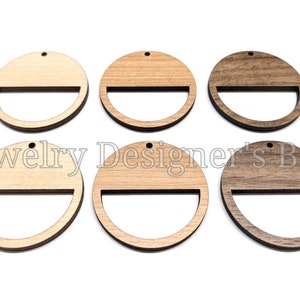 May include: Six unfinished wooden circles with a half-circle cutout. The circles are in three different wood tones: light, medium, and dark.