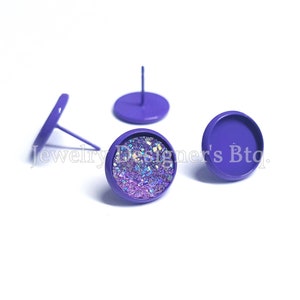 May include: Three purple metal earring bases, one with a clear iridescent glitter glue embellishment.