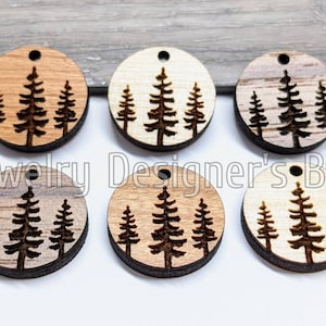 May include: Six round wooden ornaments with a laser-cut design of three pine trees. The ornaments are in various shades of brown, from light to dark.