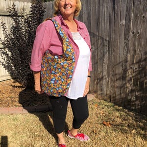 yellow and blue flowered hobo bag with matching yellow fabric interior  snap closure