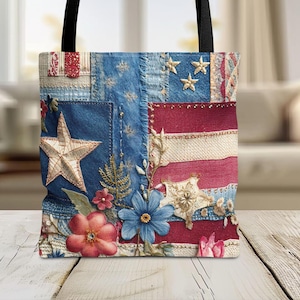 May include: Tote bag with a patriotic design. The bag features a patchwork design with denim, red and white stripes, and embroidered stars and floral accents. The bag has black handles.