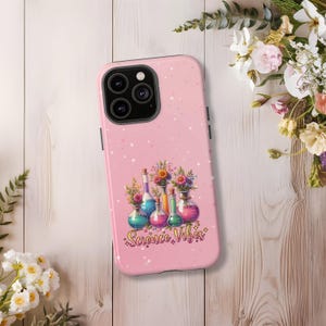May include: Pink phone case with a design of colorful potion bottles and flowers. The text "Science Vibes" is written in a yellow font.
