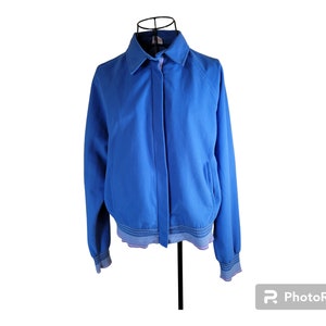 May include: A blue bomber jacket with a zipper closure and a ribbed collar, cuffs, and hem.