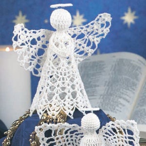 May include: Two white crocheted angels with haloes and wings. The angels are on a blue background with gold beads.