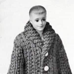 May include: A knitted cardigan with a large collar, button closure, and a pocket on the front. The cardigan is gray and has a textured knit pattern. The cardigan is being worn by a doll.