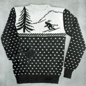 May include: A black and white knitted sweater featuring a winter scene. The design includes a skier, a pine tree, and mountains on a white background. The lower portion of the sweater has a pattern of white dots.