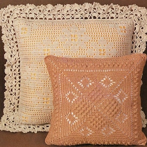 May include: Two crocheted throw pillows, one with a beige crocheted pattern and a white crocheted border, and the other with a brown crocheted pattern.