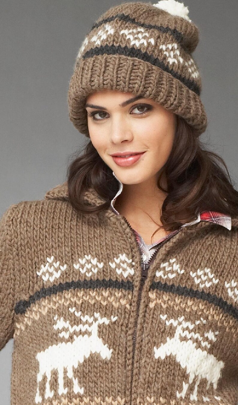 May include: A brown knitted cardigan with a zipper closure and a white reindeer pattern. The cardigan has a brown knit hat with a white pom pom on top.