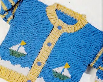 May include: A blue knitted baby cardigan with yellow stripes on the sleeves and a yellow trim around the neckline. The cardigan has two small sailboats embroidered on the front.