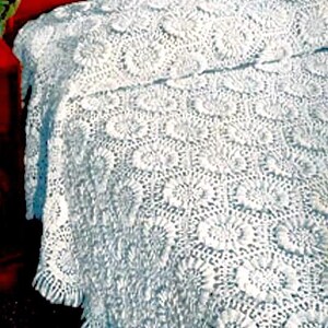 May include: White crocheted bedspread with a delicate floral pattern. The bedspread has a fringed edge and is made of a lightweight, airy fabric.
