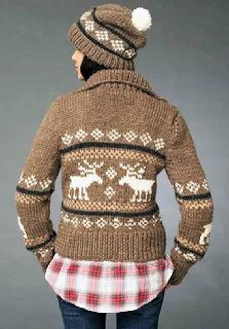 May include: Brown knitted cardigan with a white reindeer pattern and a black and white geometric pattern. The cardigan has a collar and long sleeves.