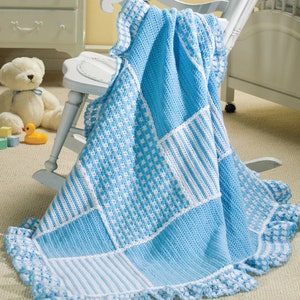 May include: A blue and white crocheted baby blanket with a scalloped edge. The blanket is made of squares with different patterns, including stripes and checkered designs.