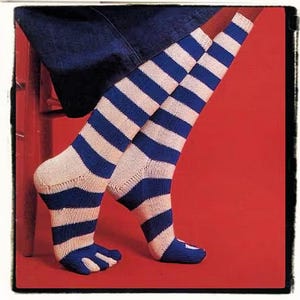 May include: A pair of striped socks with blue and white stripes. The socks are toe socks with five separate toes.