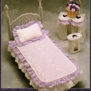 May include: A miniature bedroom set featuring a bed, nightstand, and stool. The bed has a silver headboard and footboard, with a white pillow and a pink and lavender bedspread. A small basket of flowers sits on the nightstand.