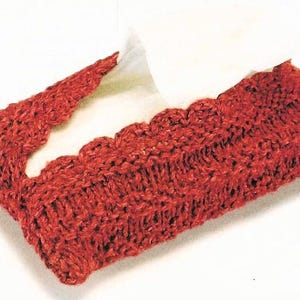 May include: A red crocheted tissue box cover with a scalloped edge.