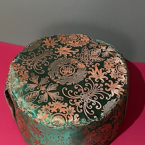 Green meditation cushion with endless knot.