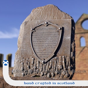 May include: A brown stone plaque with a metal shield depicting the Declaration of Arbroath. The text on the shield reads: "As long as but a hundred of us remain alive, never will we on any conditions be brought under English rule. It is in truth not for glory, nor riches, nor honours, that we are fighting, but for freedom - for that alone, which no honest man gives up but with life itself."