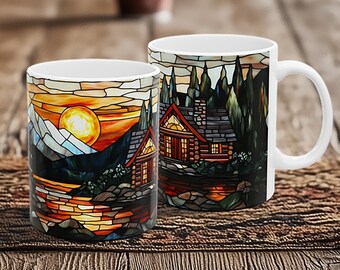 May include: Two white ceramic mugs with a stained glass design of a cabin in the woods at sunset. The design features a log cabin with a stone chimney, trees, and a lake with a reflection of the setting sun.