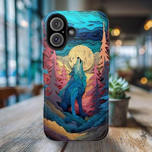 May include: A phone case with a colorful, layered paper art design featuring a wolf howling at the moon. The wolf is blue and white, and the background is a mix of blues, greens, yellows, and pinks.