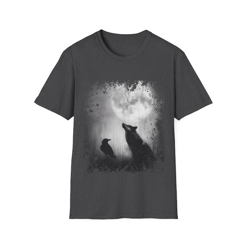 Pu&ograve; includere: T-shirt grigio scuro con grafica in bianco e nero di un lupo che ulula alla luna e un corvo. Il design ha un effetto invecchiato e strutturato. La maglietta ha girocollo e maniche corte.