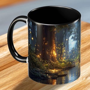 May include: Black coffee mug with a wraparound forest scene featuring a glowing, golden light. The handle and interior of the mug are black. The forest scene includes a body of water and a large tree.