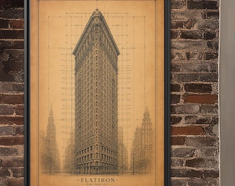 May include: A framed architectural print featuring a detailed line drawing of the Flatiron Building in New York City. The artwork is rendered in dark ink on a tan, parchment-style background, complete with technical grid lines and measurements.