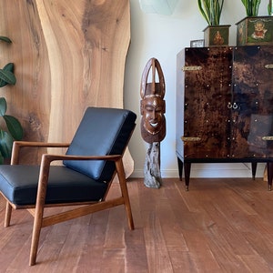 An elegant lounge chair, genuine leather, Scandinavian design,