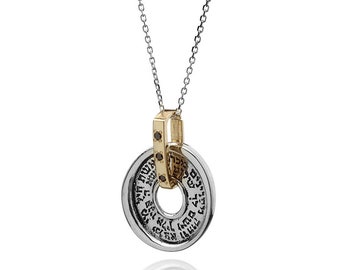 May include: A silver and gold pendant necklace with a circular charm. The charm has Hebrew text around the edge and is connected to a gold-colored bail with black accents. The necklace chain is silver.