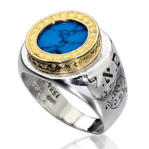 May include: A silver ring featuring a turquoise stone set within a gold bezel. The ring is engraved with Hebrew text.